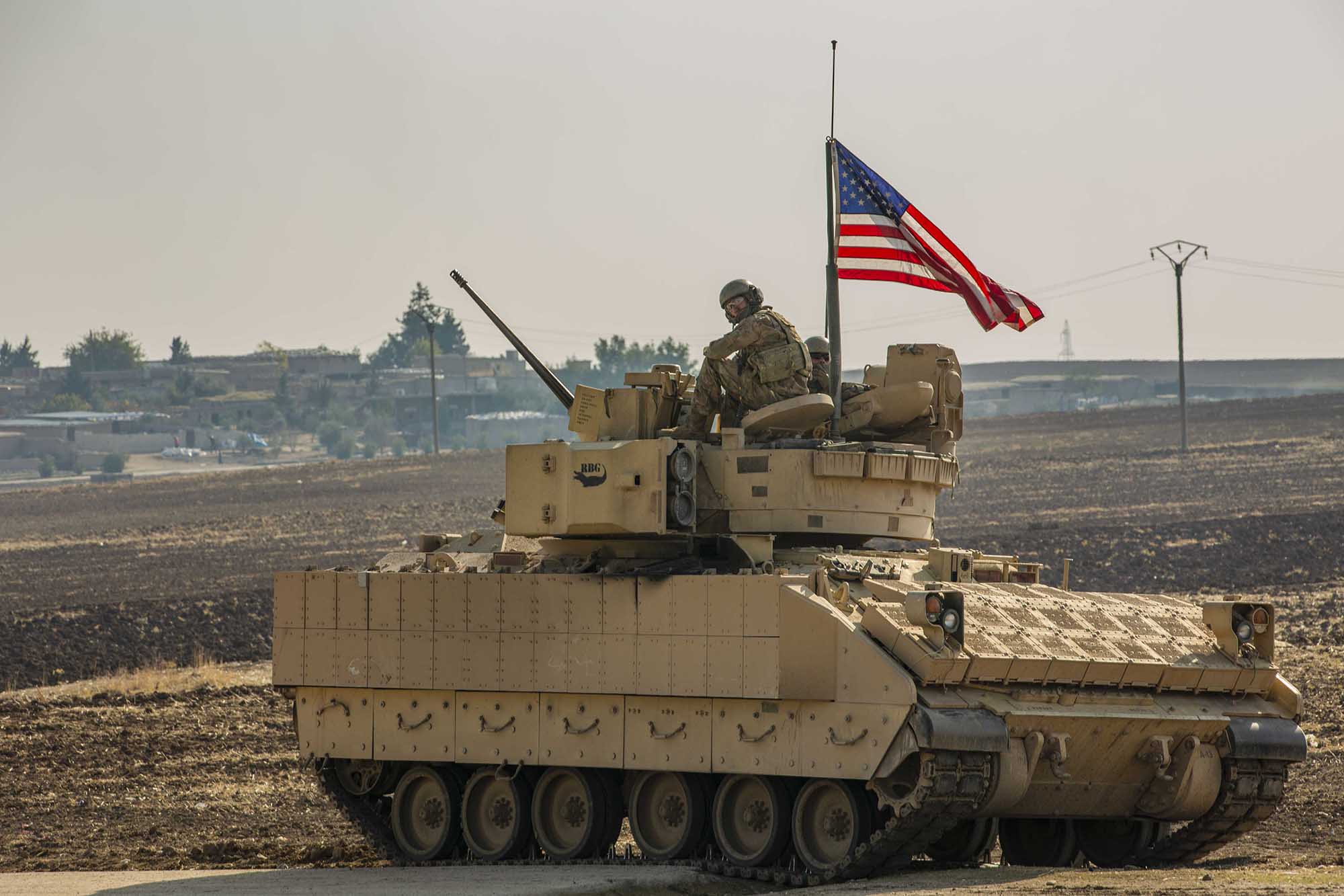 A U.S. soldier sits in the gunner’s seat of a M2 Bradley Infantry Fighting Vehicle in Syria in the Central Command  area of responsibility, Dec. 11, 2020.