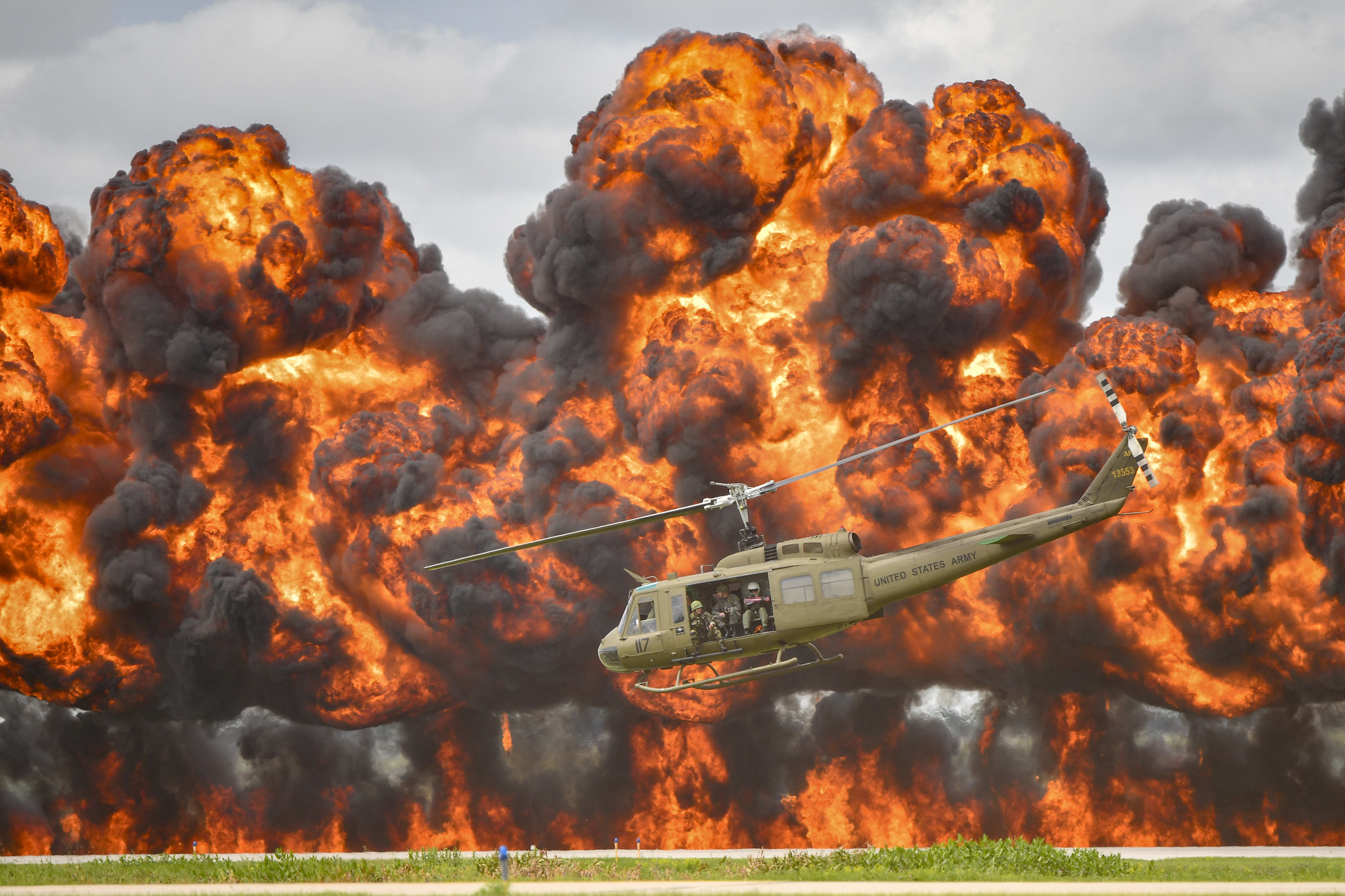 A Bell UH-1 Iroquois Helicopter, nicknamed the "Huey," takes off amidst an explosion Aug. 18, 2019, during a reenactment of a Vietnam-era combat search and rescue mission performed by Cavanaugh Flight Museum at Joe Foss Field, S.D.