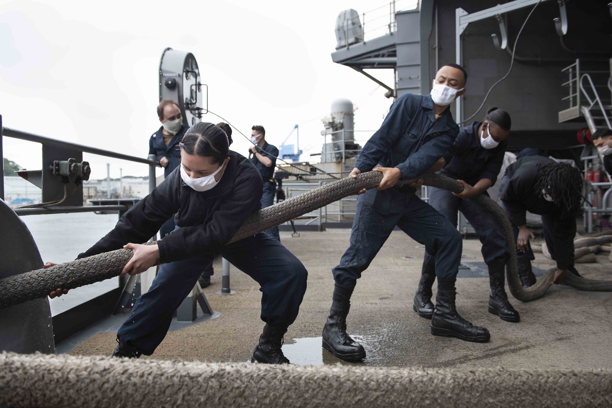 Sailors heave a mooring line on the fantail of the Navy's only forward-deployed aircraft carrier, the USS Ronald Reagan (CVN 76), in preparation to get the ship underway on May 21, 2020, in Yokosuka, Japan.