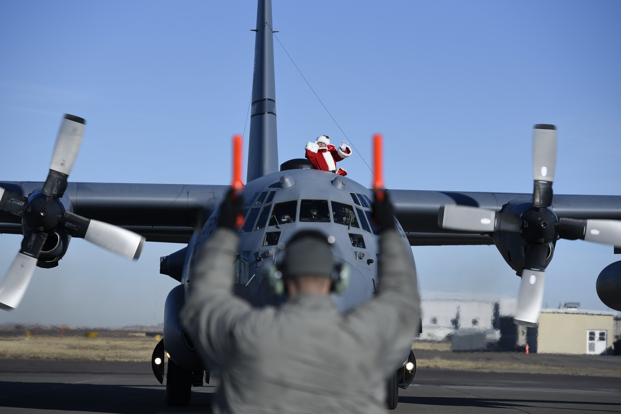 Santa Claus waves as he taxis on the ramp in a 120th Airlift Wing C-130 Hercules at Montana Air National Guard Base on Dec. 5, 2020.