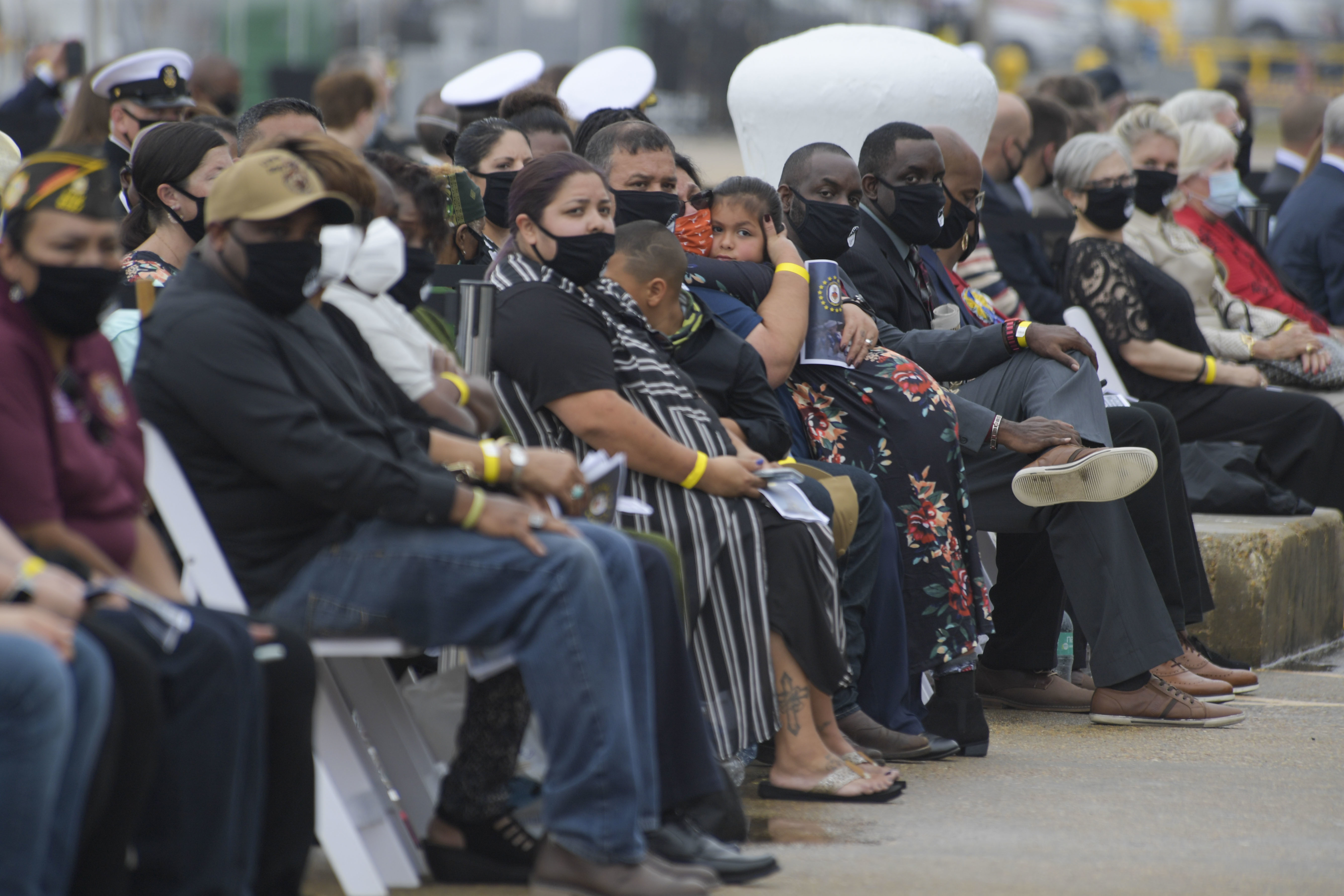 NORFOLK (Oct. 12, 2020) Gold Star families and guests watch a memorial video during the Arleigh Burke-class guided missile destroyer USS Cole (DDG 67) 20th Anniversary memorial ceremony at Naval Station Norfolk. USS Cole was attacked by terrorists at 11:18 a.m. on Oct. 12, 2000, while moored for refueling in the Port of Aden, Yemen. The explosive bomb created a 40-by-60-foot hole on the port side of the ship, and the Cole's Sailors fought fires and flooding for the following 96 hours to keep the ship afloat. Commemoration events on the 20th anniversary of the attack remember and honor the 17 Sailors who were killed, the 37 who were injured and the Gold Star families. (U.S. Navy photo by Mass Communication Specialist 2nd Class Darien G. Kenney)